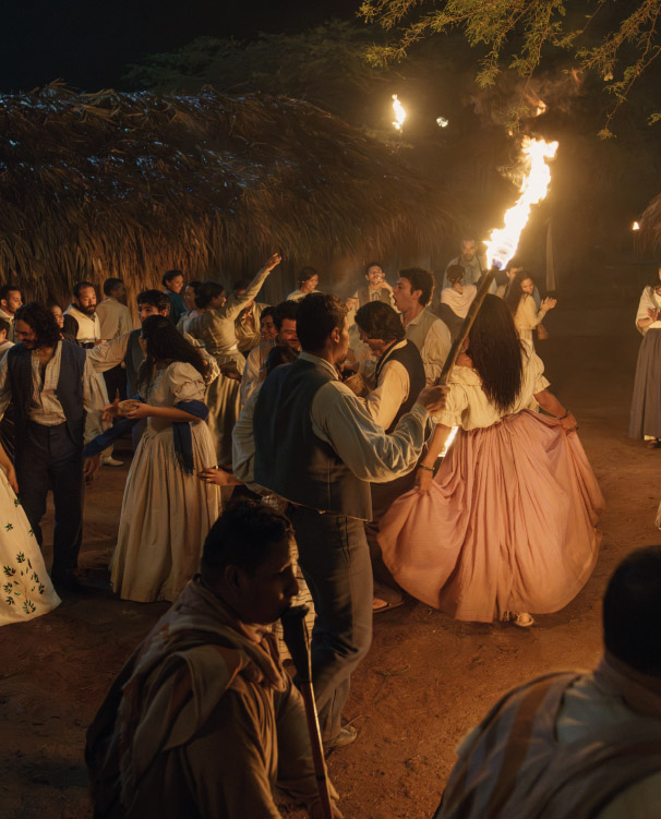 Traditional night party with people dancing in traditional costumes.