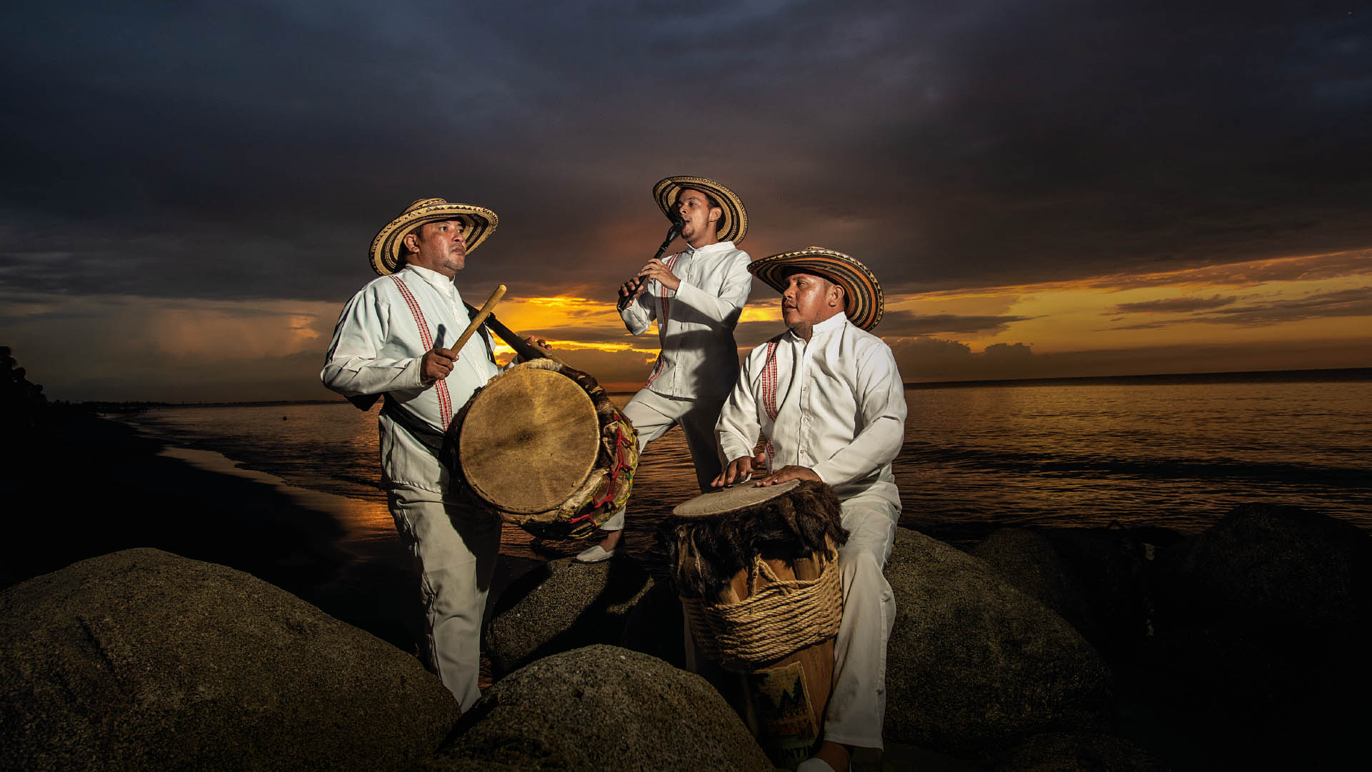 Men playing Colombian typical instruments by the sea of the country of beauty