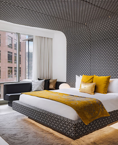 Modern room at the W Bogotá hotel with geometric design and yellow details