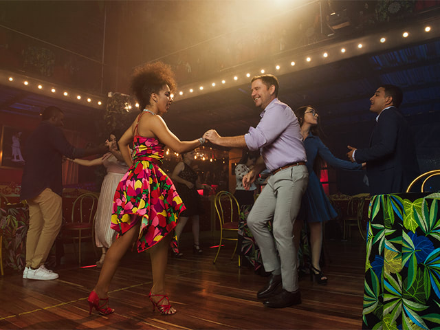 Couples dancing in a nightclub at the Cali Fair.