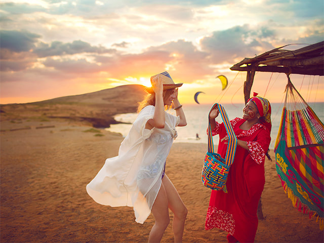 a member of the Wayuu indigenous group with a tourist at sunset in Cabo de la Vela.