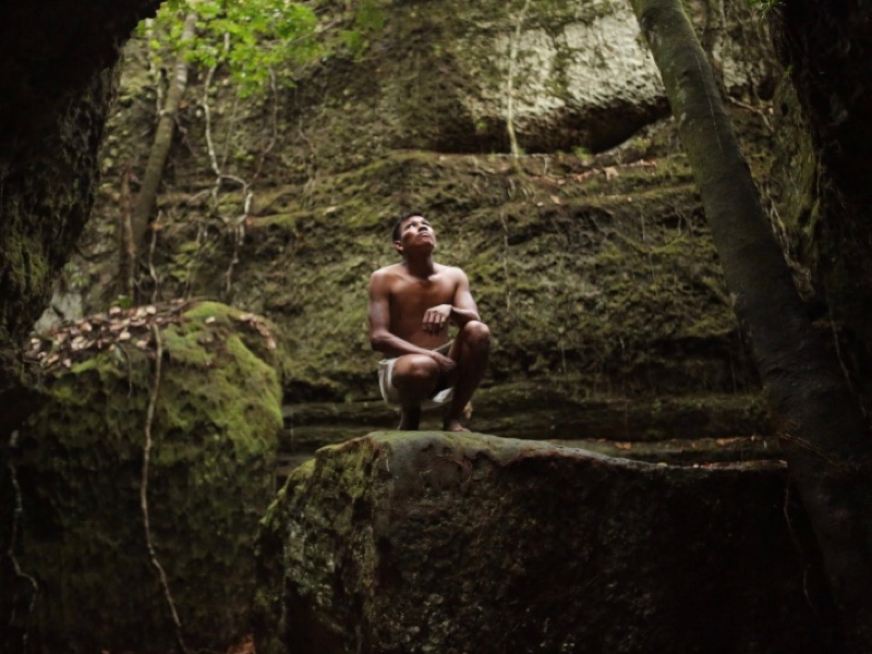 There’s an indigenous inside a cave, a place that you’ll see during your family holiday in the Amazon.