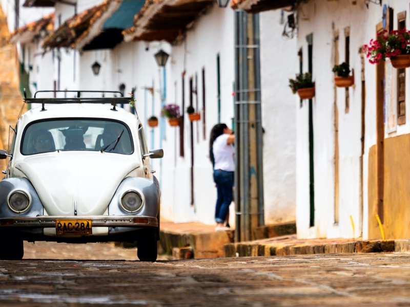 View of a white car on the streets of Barichara, one of the destinations in Colombia.