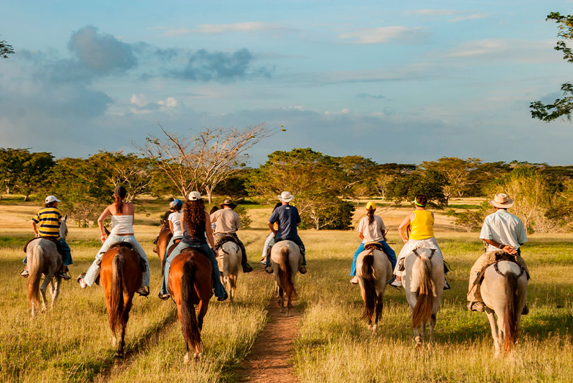 Family on a horseback ride in the Colombian plains 