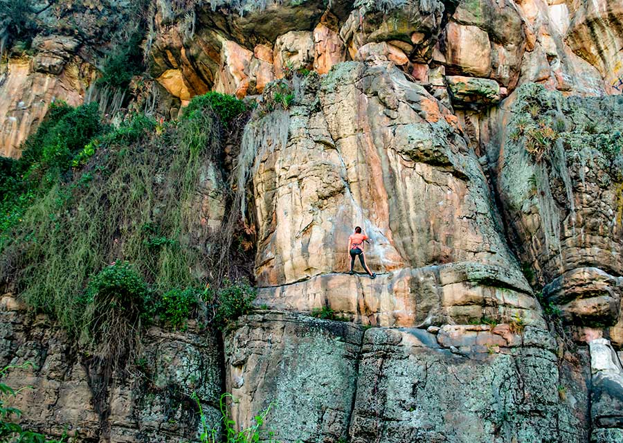 Nature and adventure tourism: woman climbing a mountain in Guasca Colombia