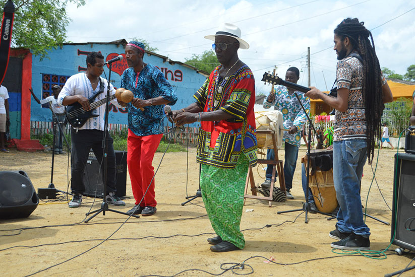 Men from San Basilio de Palenque playing music in an open space
