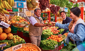 Market vendor selling a mango to a woman