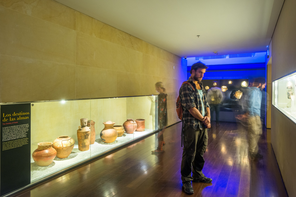 A young man observes the works at the Gold Museum in Bogotá.