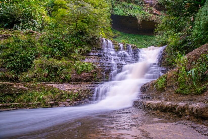 Close-up view of a waterfall called Juan Curi in San Gil, surrounded by thick vegetation
