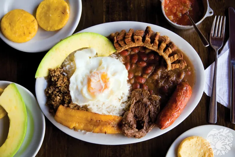 Enjoy Bandeja Paisa, a traditional Colombian dish