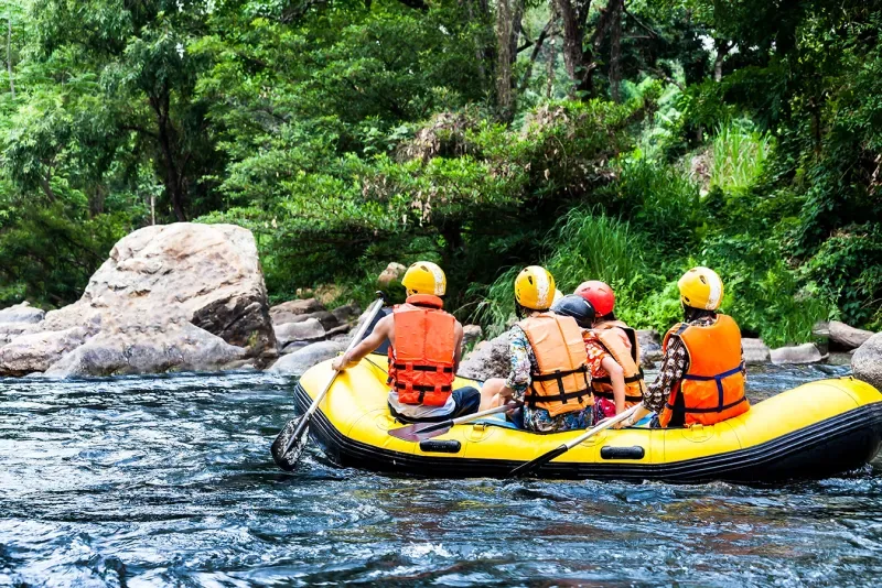 Several tourists rafting on the Amazon River, seeing its extent and strong currents