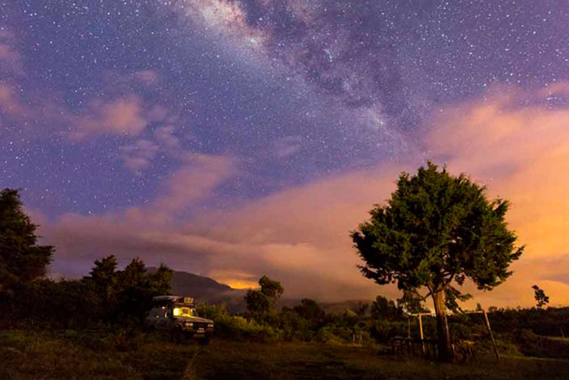 Starry sky with the Milky Way over a rural night landscape